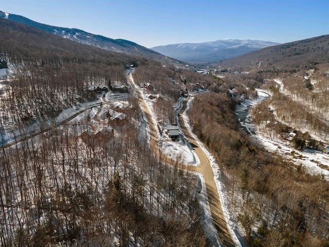 snowy aerial view featuring a mountain view