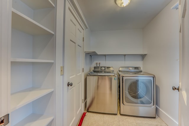 washroom with washing machine and clothes dryer, hookup for a washing machine, and light tile flooring