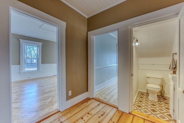 hallway featuring light parquet floors and crown molding