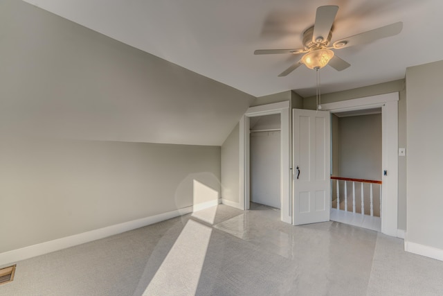 additional living space featuring light carpet, vaulted ceiling, and ceiling fan