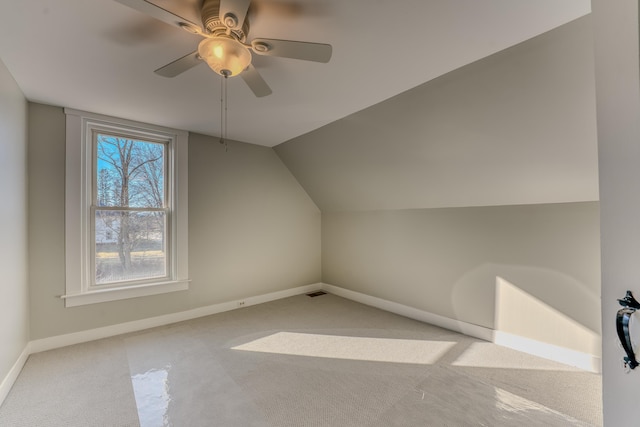 additional living space with light carpet, vaulted ceiling, and ceiling fan