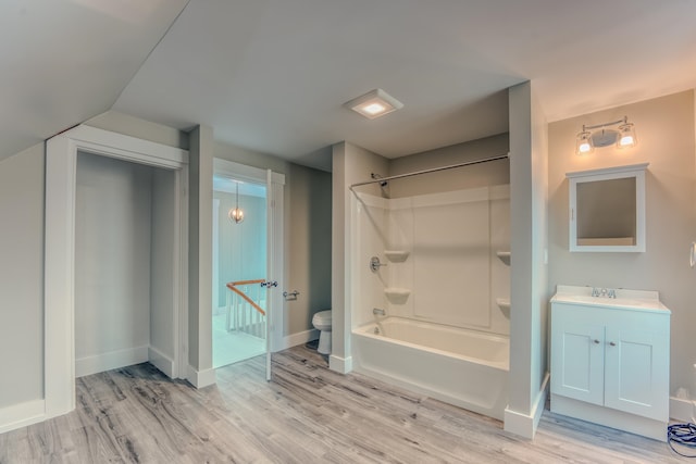 full bathroom with shower / bath combination, toilet, vanity, and wood-type flooring