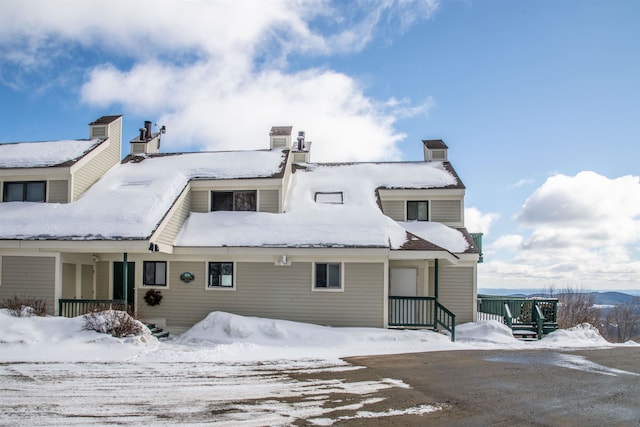 view of snow covered rear of property