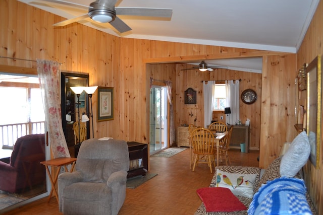 534 Patton Shore Rd, Franklin, VT 05457 - living room with wooden walls, crown molding, vaulted ceiling, ceiling fan, and light parquet flooring