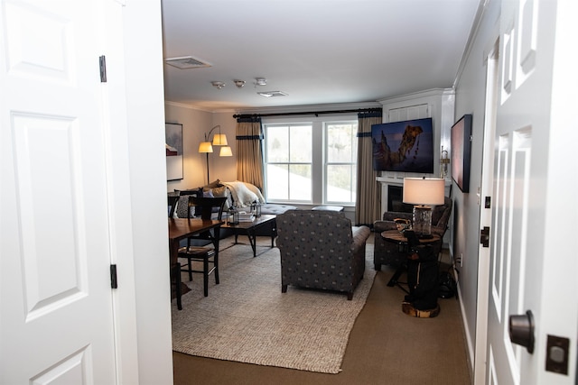 carpeted living room with ornamental molding