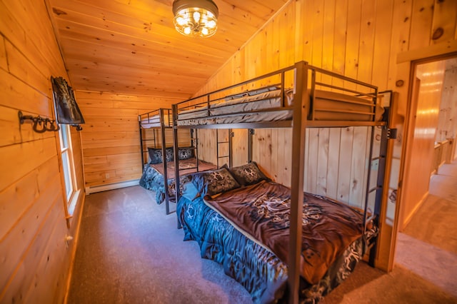 carpeted bedroom featuring a notable chandelier, wood ceiling, wood walls, and vaulted ceiling