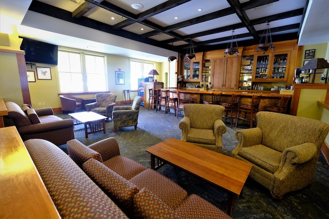 living room featuring bar area, coffered ceiling, and beamed ceiling