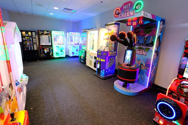 game room with a paneled ceiling