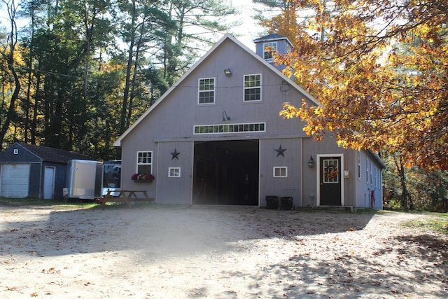 203 Kingston Rd, Danville, NH 03819 - view of front facade with an outdoor structure, a garage, and driveway