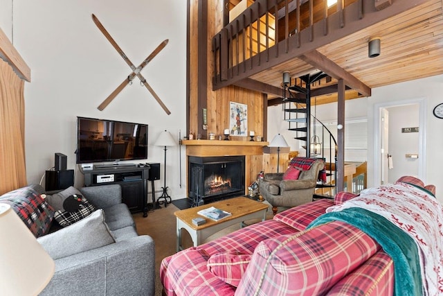 carpeted living room featuring a towering ceiling and wood ceiling