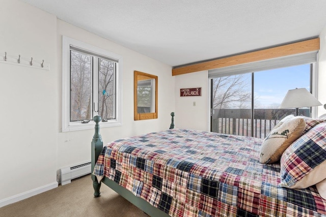 bedroom with a textured ceiling, carpet floors, a baseboard radiator, and multiple windows