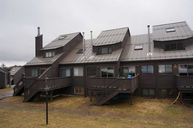 back of house with a yard and a deck