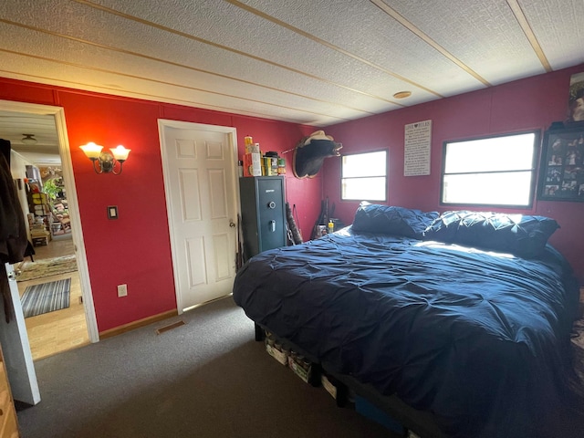 carpeted bedroom with a textured ceiling