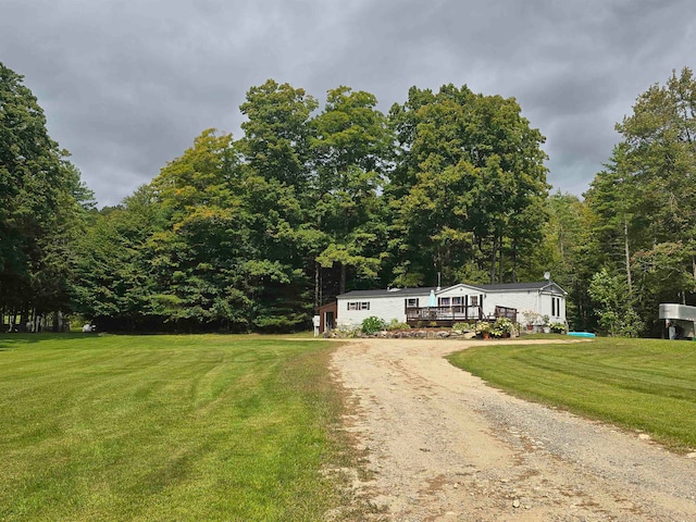 view of front of property featuring a front lawn and a deck