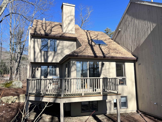 back of house featuring a wooden deck