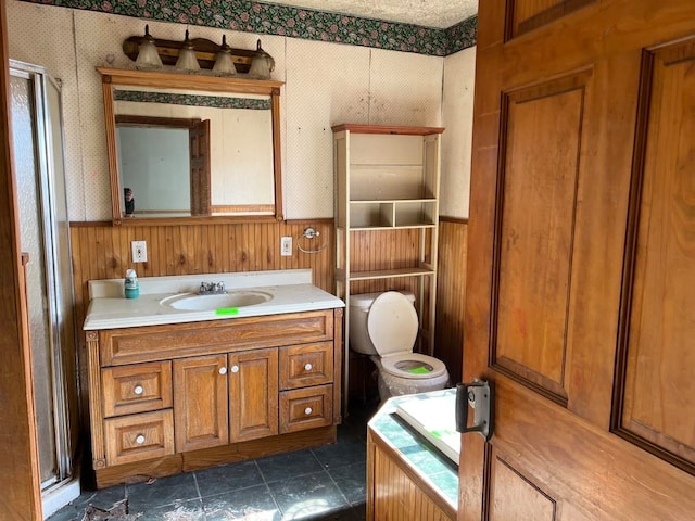 bathroom featuring an enclosed shower, toilet, vanity, and tile flooring