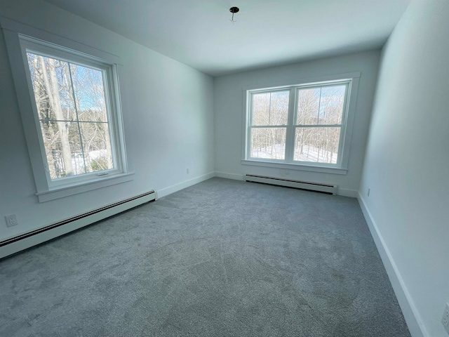 unfurnished room featuring baseboard heating and carpet flooring