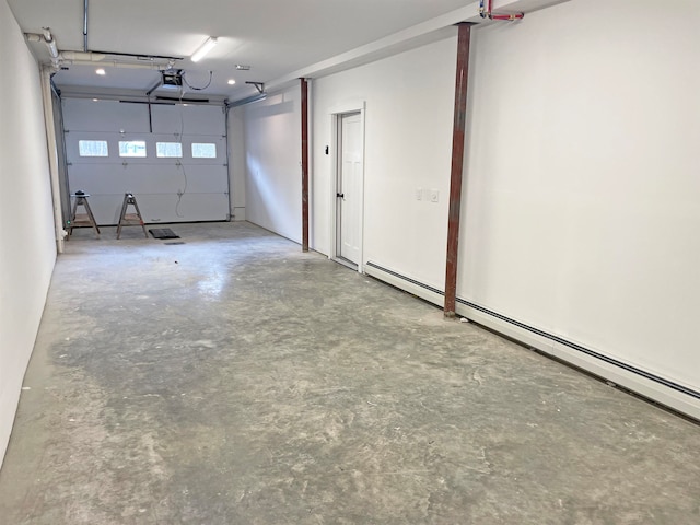 garage featuring a garage door opener and a baseboard heating unit