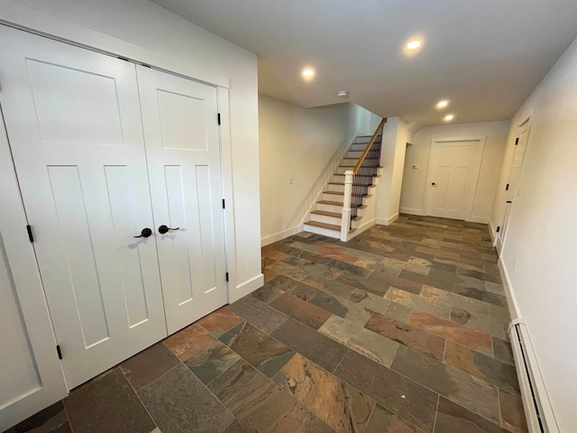 interior space featuring dark tile patterned flooring and baseboard heating