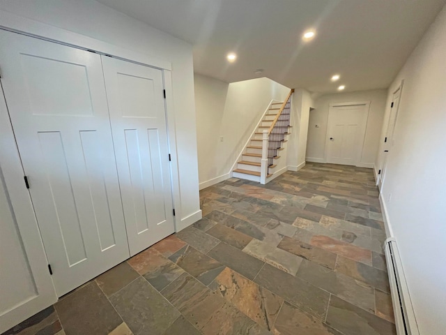 tiled foyer entrance with a baseboard heating unit