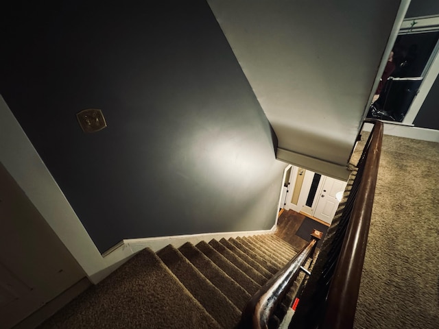 staircase with dark carpet