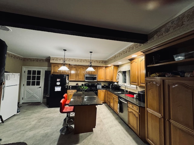 kitchen with a center island, stainless steel appliances, a kitchen bar, decorative light fixtures, and sink