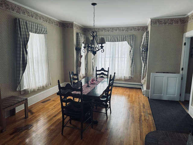 dining area featuring crown molding, dark hardwood / wood-style floors, a baseboard radiator, and a chandelier