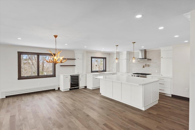 kitchen with wine cooler, white cabinets, dark hardwood / wood-style floors, and pendant lighting