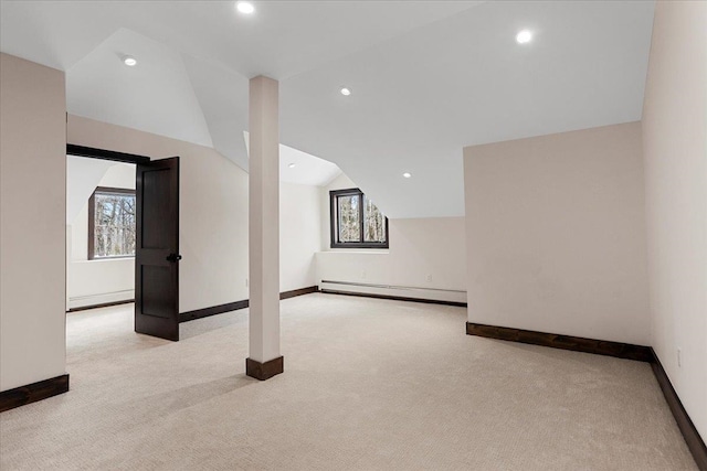 interior space with a baseboard heating unit and light colored carpet