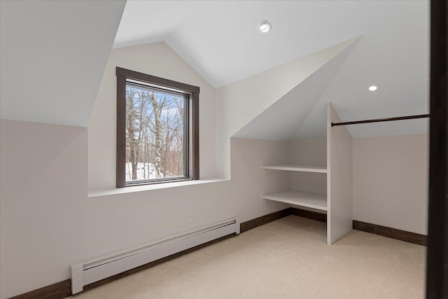 bonus room featuring lofted ceiling, baseboard heating, and light colored carpet