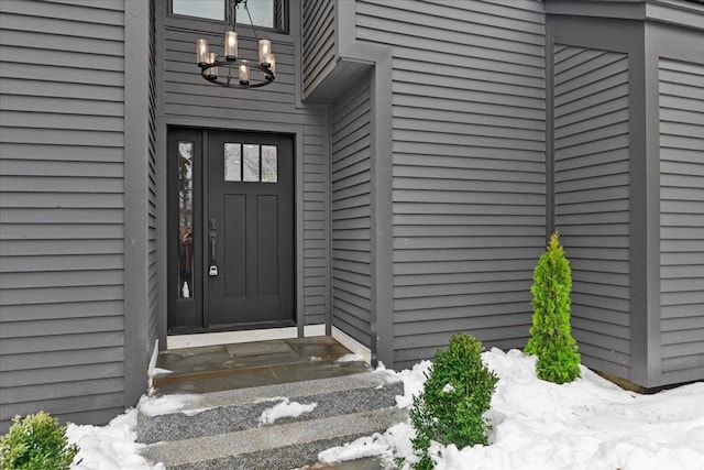 view of snow covered property entrance