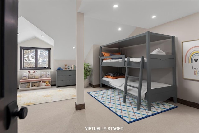 bedroom with lofted ceiling and carpet floors