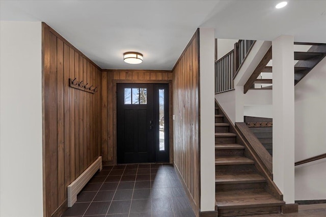 foyer with wood walls