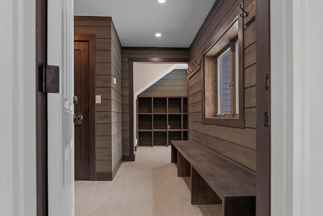 mudroom with wooden walls