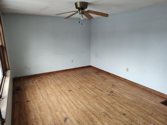 empty room with light hardwood / wood-style floors and ceiling fan