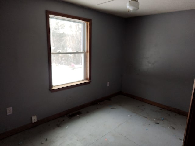 empty room featuring ceiling fan and a healthy amount of sunlight