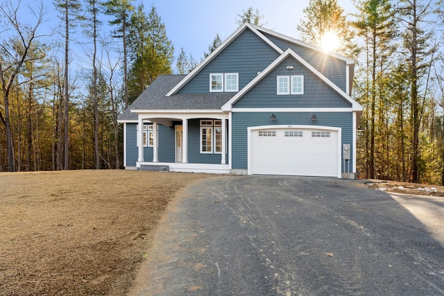 view of front of home featuring covered porch and a garage