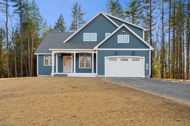 view of front of home featuring a porch and a garage