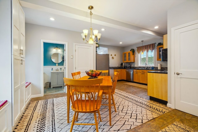 tiled dining area with beamed ceiling, sink, and a chandelier