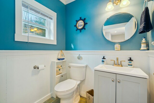 bathroom featuring toilet and vanity with extensive cabinet space