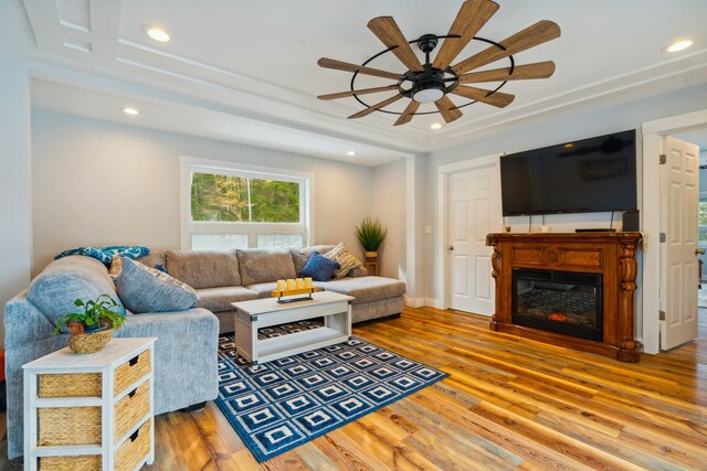 living room featuring ceiling fan and hardwood / wood-style flooring