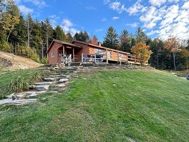 17 Tracy Hill Rd, Northfield, VT 05663 - rear view of house with a lawn, a deck, and a wooded view