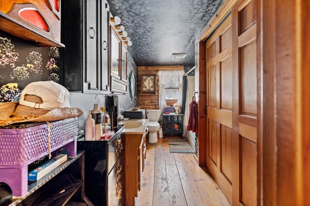 interior space featuring a textured ceiling and light hardwood / wood-style flooring