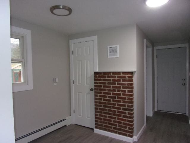 interior space with a baseboard radiator