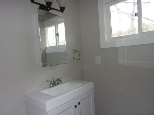 bathroom featuring a chandelier and oversized vanity