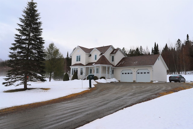 view of front facade featuring a garage and covered porch