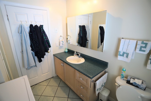 bathroom featuring vanity, tile patterned flooring, and toilet