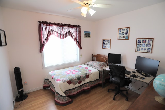 bedroom with ceiling fan and light wood-type flooring