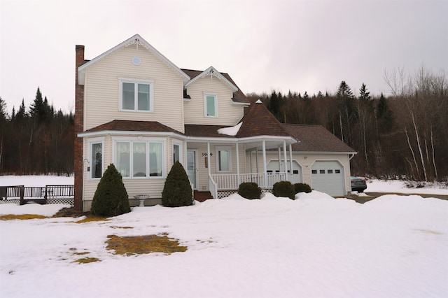 view of front of property with a garage and a porch