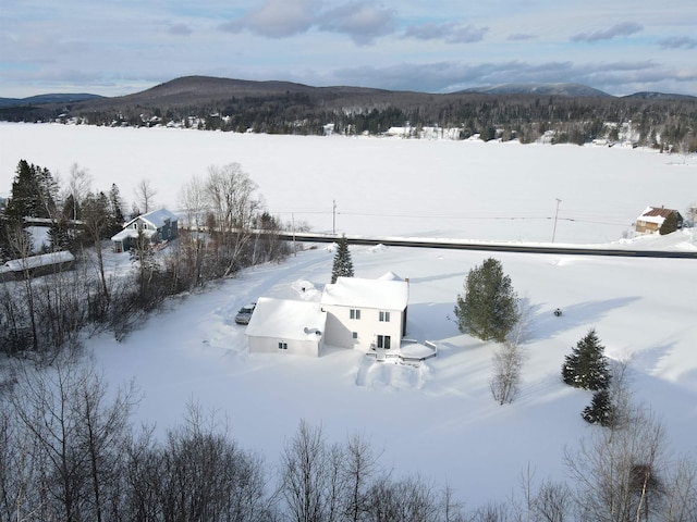 snowy aerial view featuring a mountain view